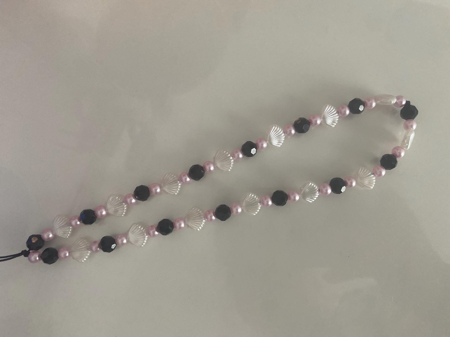 Seashell Dreams Phone Charm – Handmade Beaded Wrist Strap in Pearl Pink & Black Tones