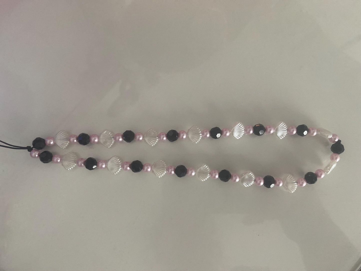 Seashell Dreams Phone Charm – Handmade Beaded Wrist Strap in Pearl Pink & Black Tones